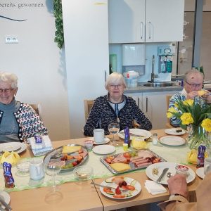 Senioren sitzen gemeinsam beim Frühstück